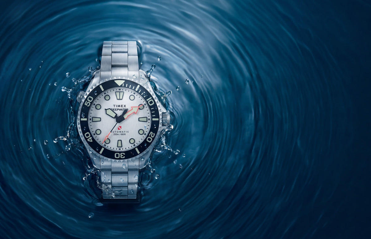Deepwater Meridian 200 HEV Automatic with a silver-tone dial and stainless-steel bracelet surrounded by splashing blue water.