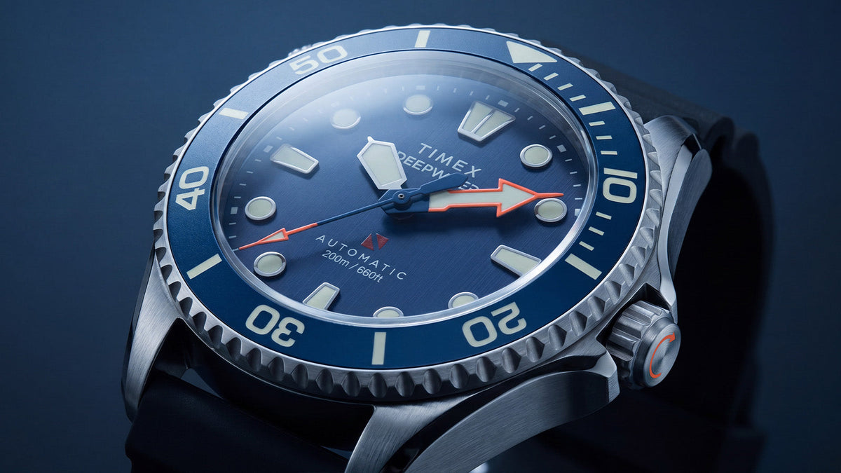 Angled close-up of the Deepwater Meridian 200 HEV Automatic’s blue dial, luminous markers, red arrow hands, and blue dive bezel.