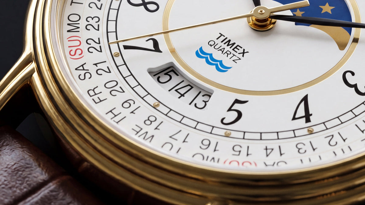 Close-up of the watch dial highlighting the calendar scale, date window, Timex Quartz logo, and moon phase display.