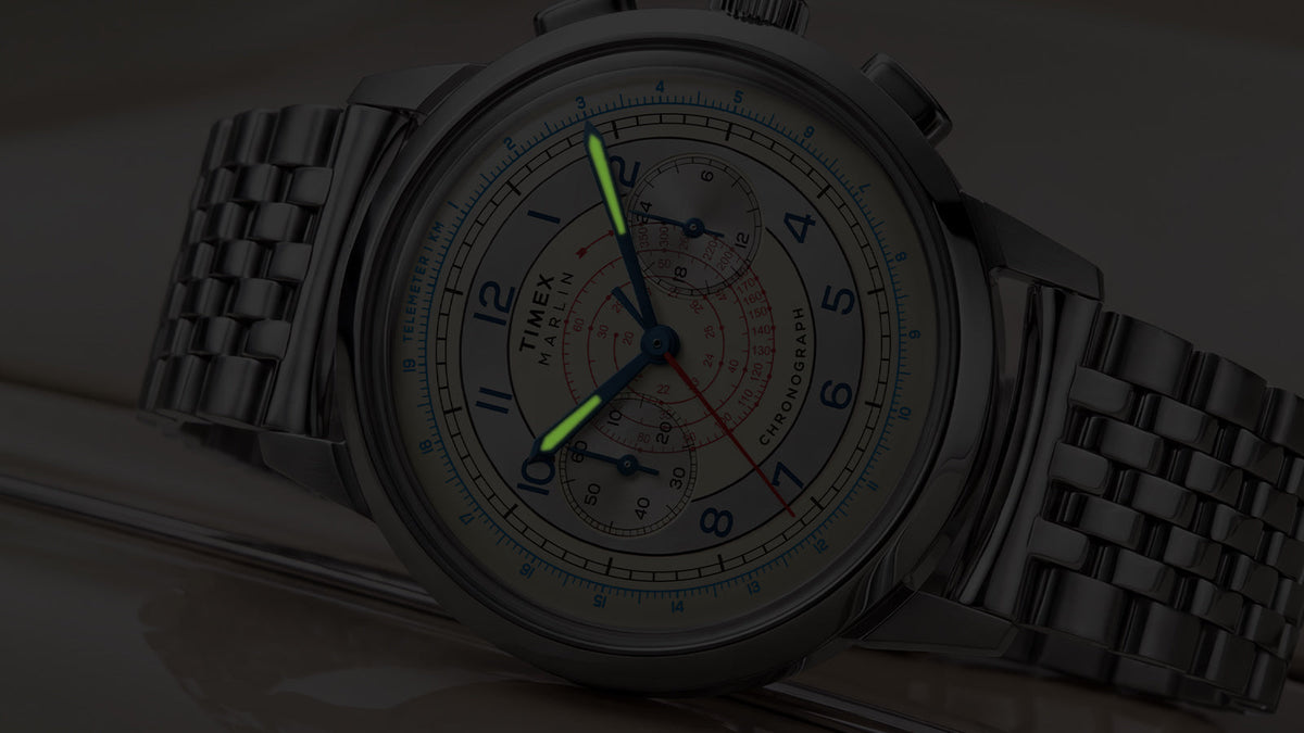 Close-up of the Marlin® Neo Classic Chronograph in low light with green luminous hour and minute hands.