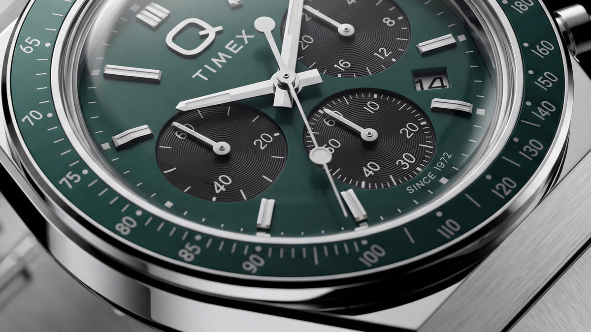 Close-up of the Q Timex Chronograph’s green dial, black subdials, date window, and tachymeter bezel.