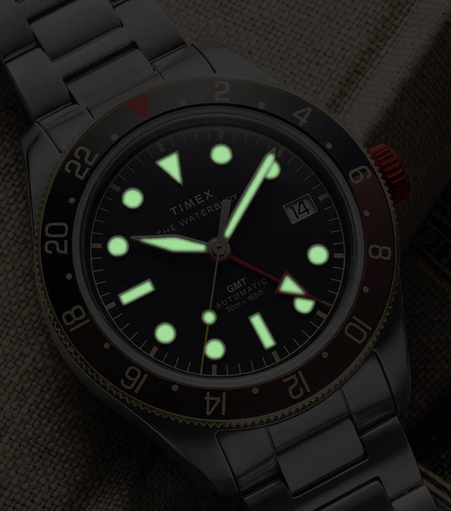 Waterbury Heritage Automatic GMT watch in low light, highlighting its luminous hands and hour markers.