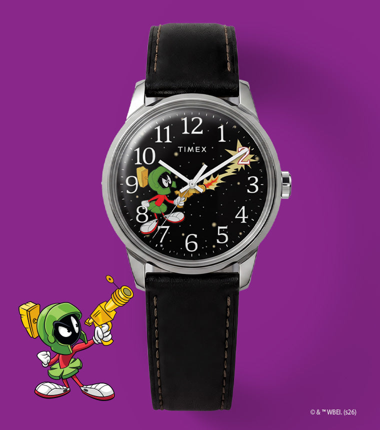 TW2Y99300 Looney Tunes Marvin the Martian x Timex Easy Reader® watch with a black character dial and black leather strap beside Marvin artwork on purple.