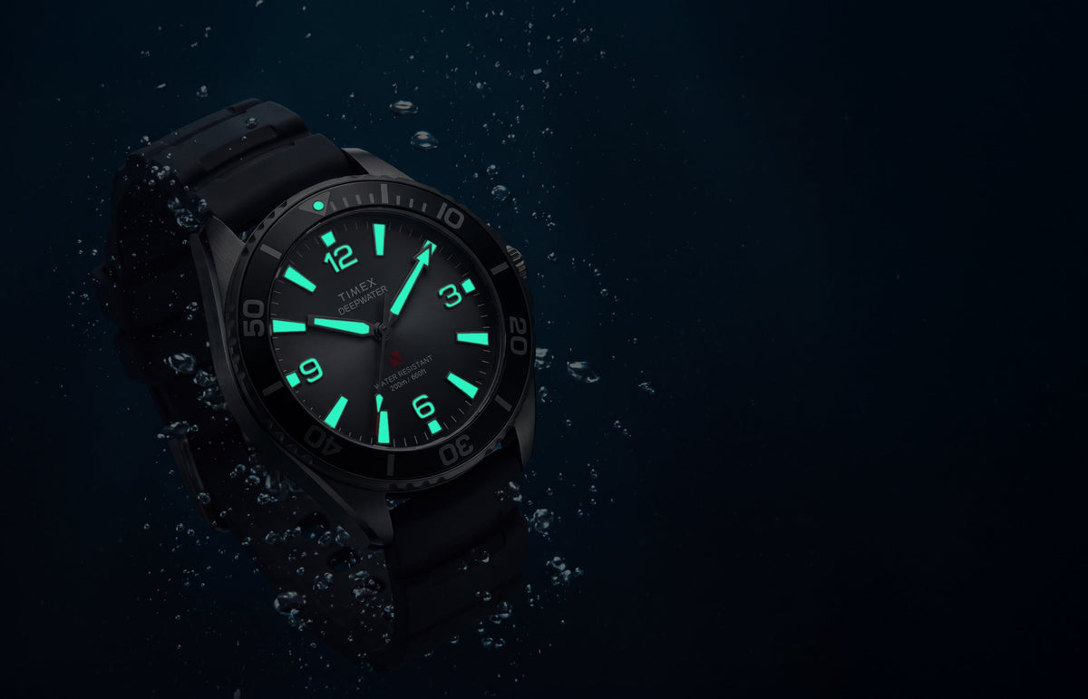 TW3A02000 Deepwater Arctic 200 watch underwater with luminous hands and hour markers glowing aqua.