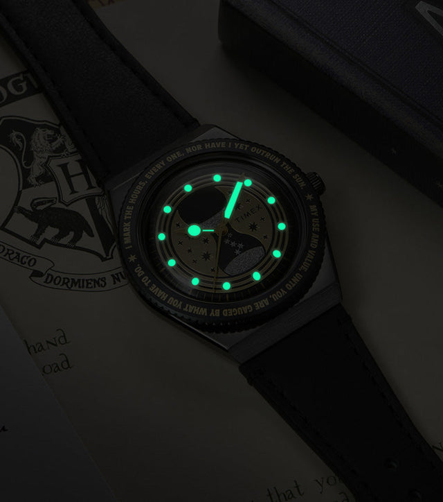 TW2Y76000 The watch in darkness, showing its glowing green hands and hour markers.