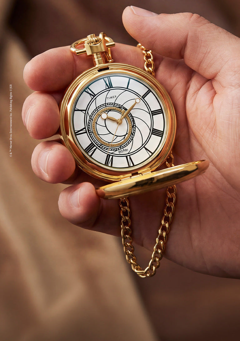 TW2Y99600 Hand holding the open pocket watch, with its Roman numeral dial and gold-tone chain visible.