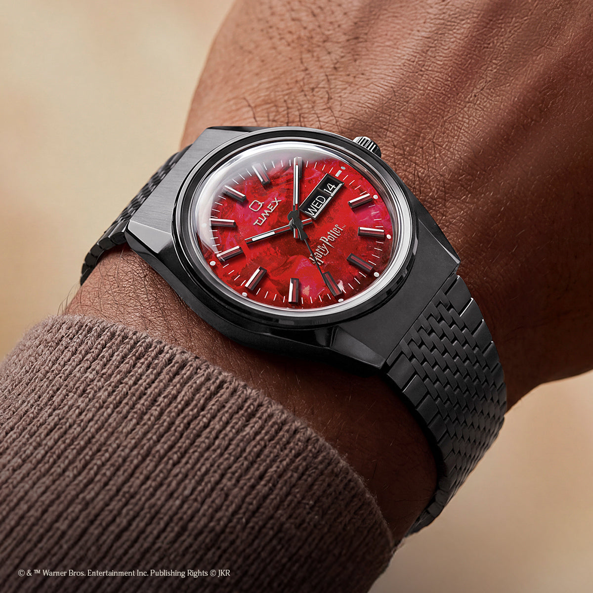 TW2Y99700 Harry Potter x Q Timex watch with a red Sorcerer’s Stone-inspired dial and black bracelet worn on the wrist.