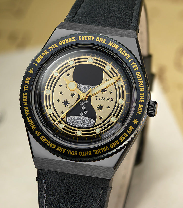 TW2Y76000 Harry Potter x Q Timex Time Turner watch, showing its black leather strap, gold-tone hands, star-patterned dial, and engraved lettering around the bezel.