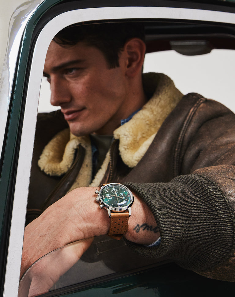 Timex Marlin Chronograph Tachymeter in a man's wrist while driving a car