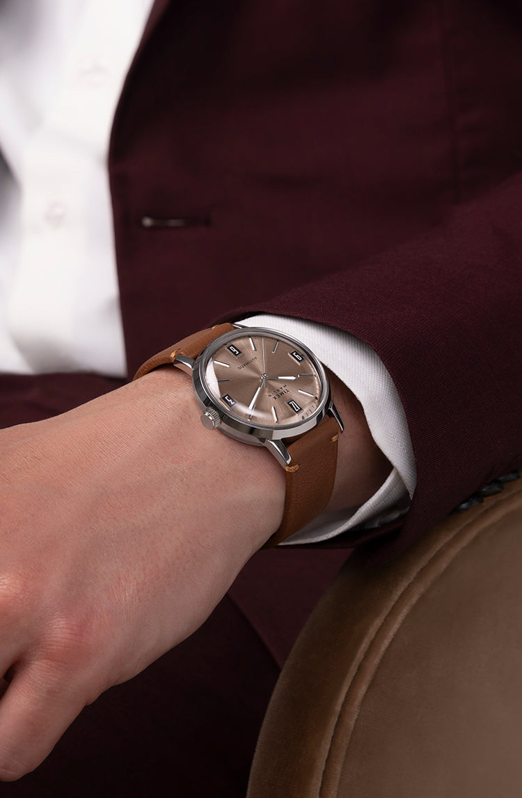 A man wearing Marlin Automatic on his left wrist