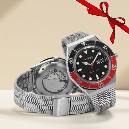 Timex M79 Black and Red Color with Christmas Ribbon at the upper right
