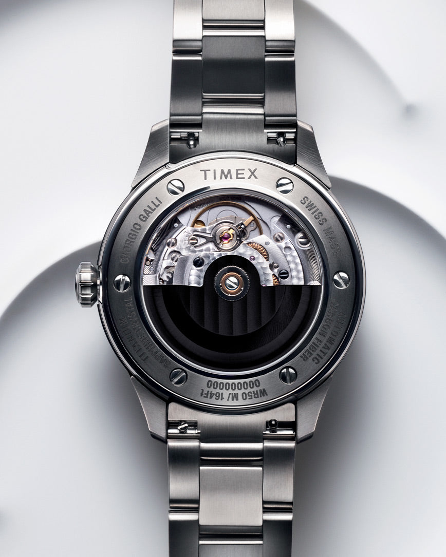 A close-up shot of the Giorgio Galli S2Ti watch, featuring a sleek titanium case and a minimalist silver dial. The timepiece has a brushed stainless steel bracelet and subtle engraved details, reflecting a modern yet timeless design. The polished hands and indices enhance the refined aesthetic, while the Swiss-made automatic movement ensures precision.