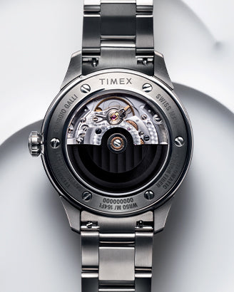 A close-up shot of the Giorgio Galli S2Ti watch, featuring a sleek titanium case and a minimalist silver dial. The timepiece has a brushed stainless steel bracelet and subtle engraved details, reflecting a modern yet timeless design. The polished hands and indices enhance the refined aesthetic, while the Swiss-made automatic movement ensures precision.