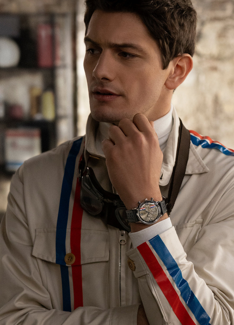 A man in a racing suite wearing Marlin® Chronograph 40mm Leather Strap Watch with sub-dial decorated with the checkered flags