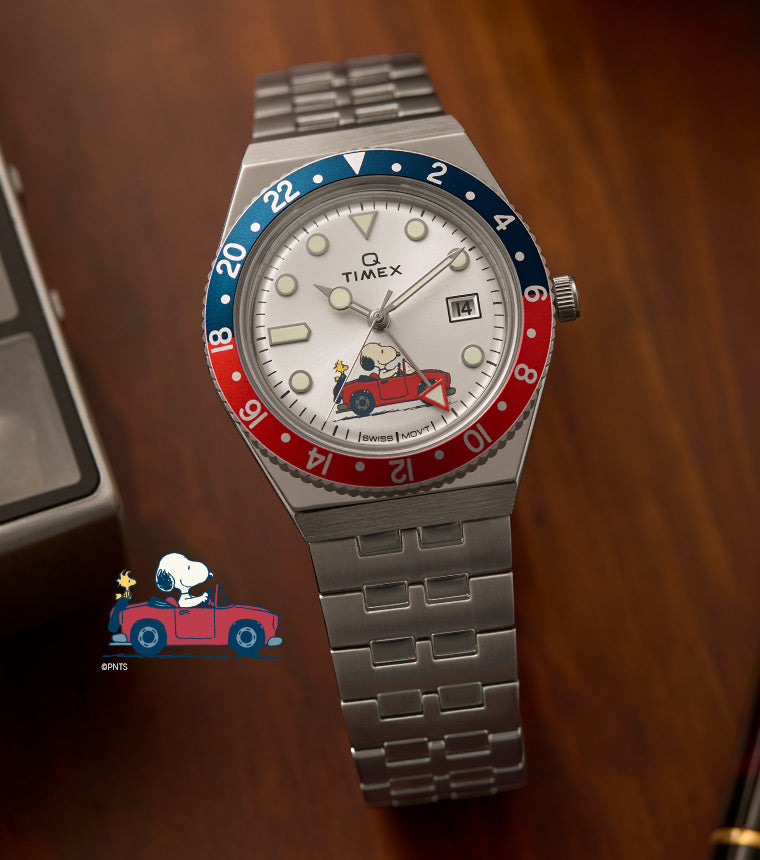 Peanuts	Q GMT Peanuts Red Car White Dial Silver-tone Bracelet with Snoopy Cartoon at the side.