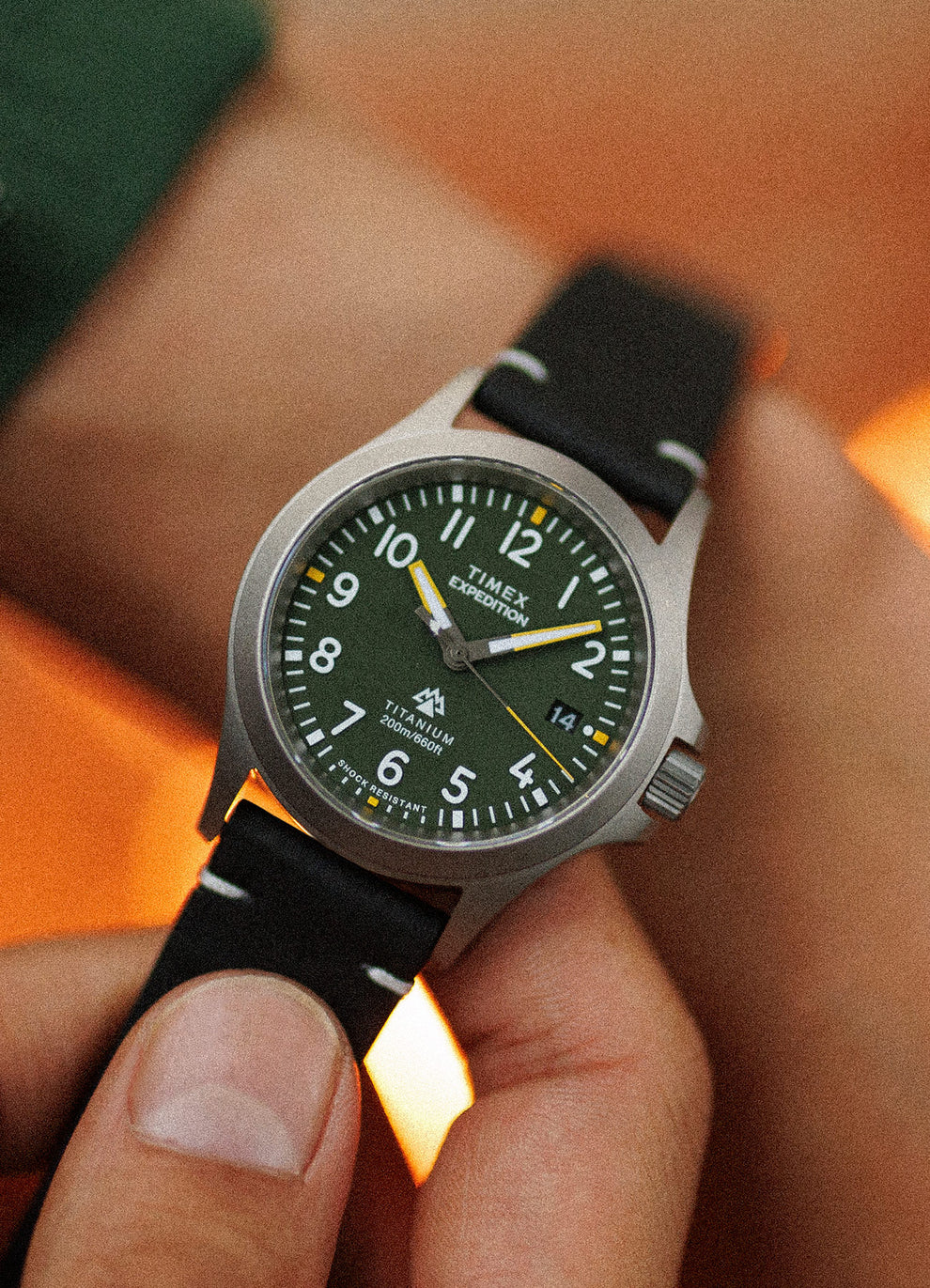 A man showing his Expedition Titanium QA (38mm) Light Gray Dial and Black Leather in his wrist
