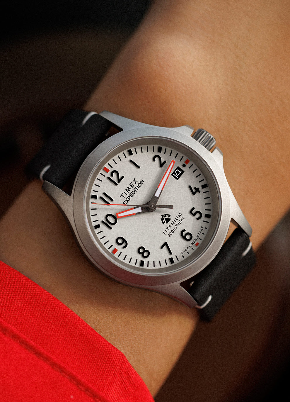 A man showing his Expedition Titanium QA (38mm) Light Gray Dial and Black Leather in his wrist
