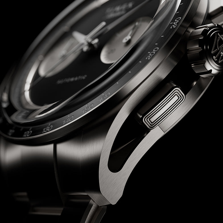 Side detail of Timex Atelier Chronograph Automatic Ti M1a titanium case showing tachymeter bezel, crown, and chronograph pusher