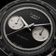 Close-up of Timex Atelier Chronograph Automatic Ti M1a black dial with dual subdials and tachymeter scale