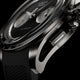 Macro view of Timex Atelier Chronograph Automatic Ti M1a titanium case, crown, and chronograph pusher with rubber strap