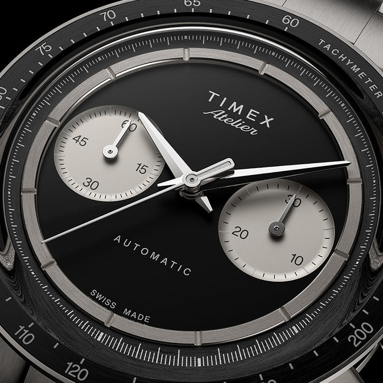 Close-up of the Timex Atelier Chronograph Automatic M1a Ti black dial featuring silver-tone sub-dials, applied markers, and polished chronograph hands.