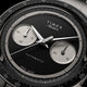 Close-up of the Timex Atelier Chronograph Automatic M1a Ti black dial featuring silver-tone sub-dials, applied markers, and polished chronograph hands.