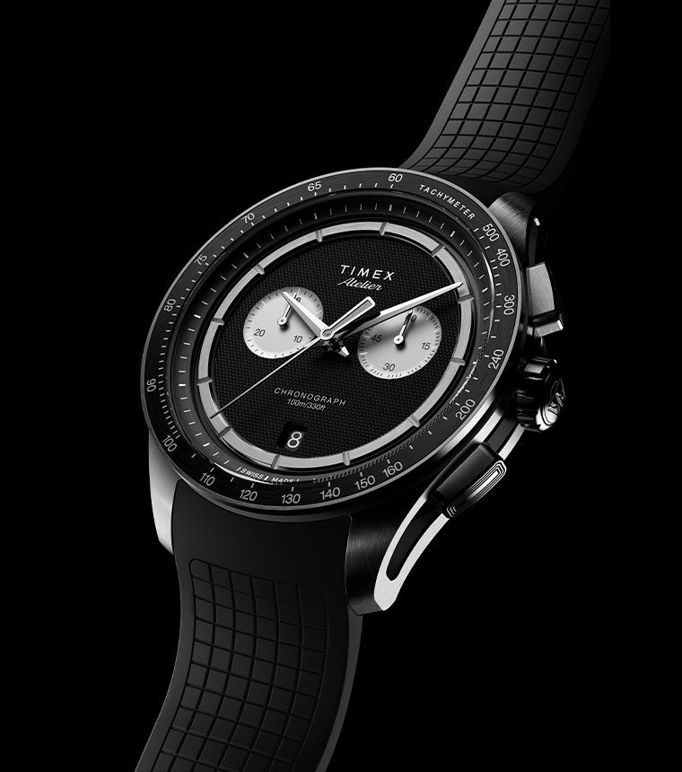 Timex Atelier Chronograph Quartz M1a 40mm Swiss Made watch with black dial and NBR synthetic rubber strap angled on dark background