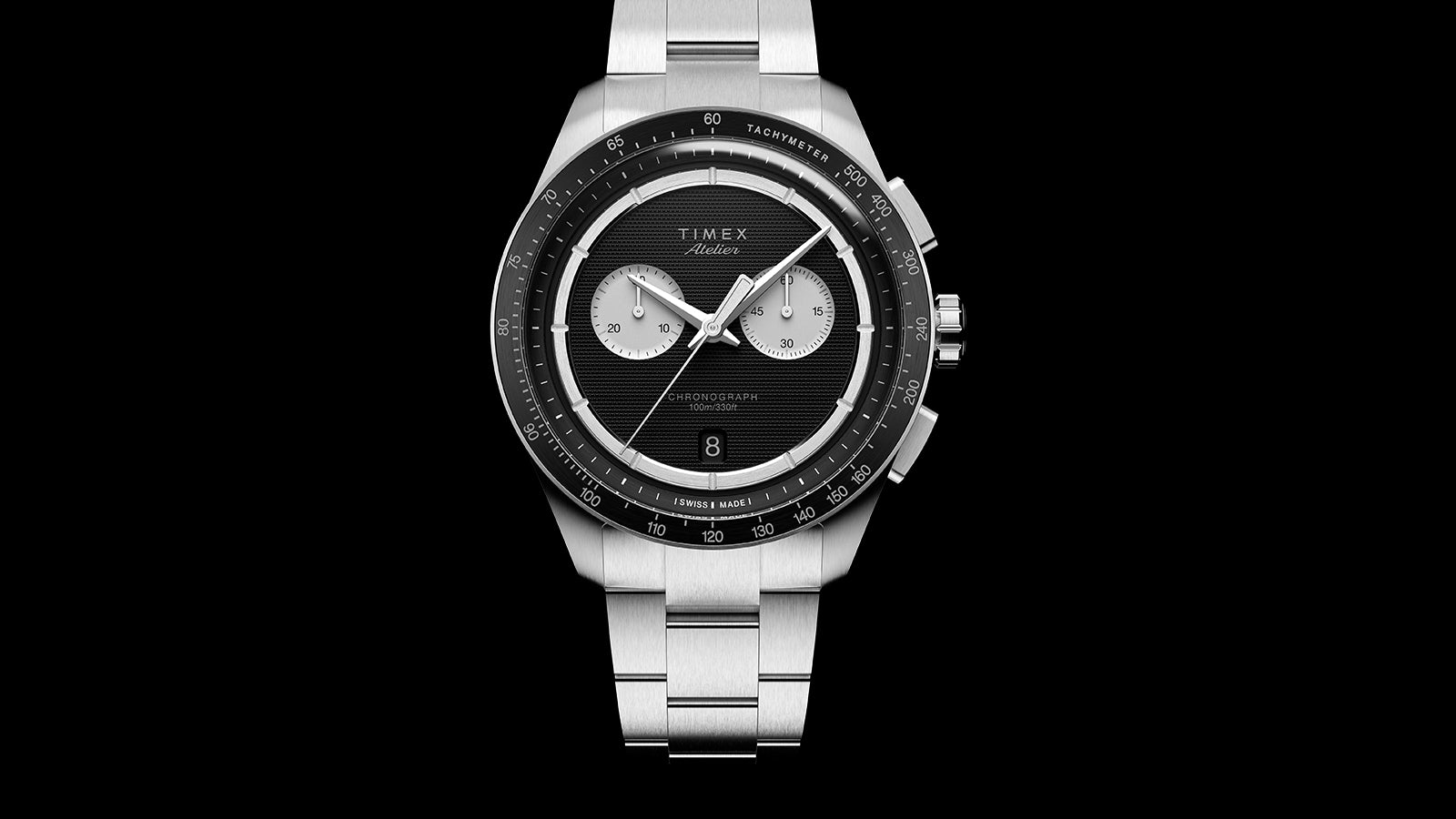 Front view of Timex Atelier Chronograph Quartz M1a with black dial, dual subdials, date window, and tachymeter scale