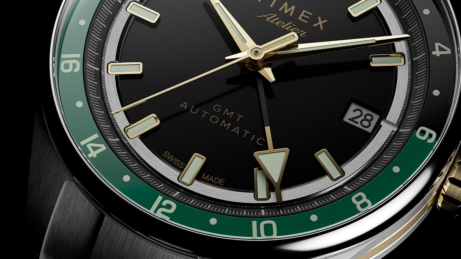 Detailed close-up of the GMT hand, date window, luminous hour markers, and green 24-hour scale.