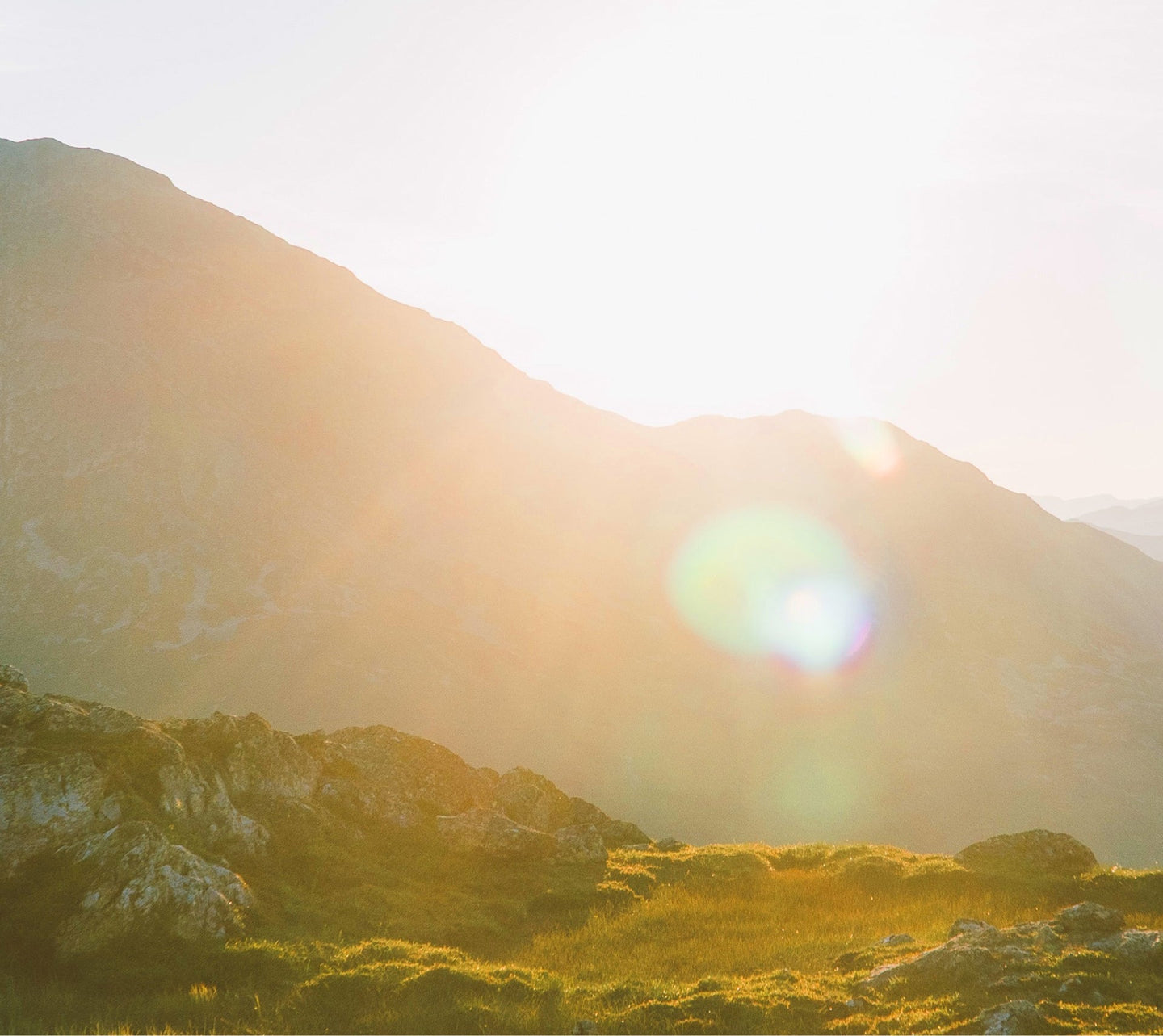 A mountain with Sun rays