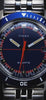 A dynamic video showcasing the Q Timex® 1971 Velocity watch, featuring close-up shots of its blue dial, orange accents, and stainless steel bracelet. The video highlights its retro 1970s racing-inspired design, bold color palette, and precision craftsmanship with smooth camera motion and reflections on a red surface.