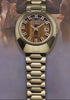 Q Timex® 1972 Time Machine Reissue wristwatch featuring a polished stainless-steel case with a faceted design and hexagonal-link bracelet. The watch showcases a deep blue sunray dial with bold silver-tone hour markers accented in black, luminous hands, and a framed date window at 3 o’clock. The video captures multiple angles, including close-ups of the dial, side profile highlighting the domed crystal, and smooth bracelet links, all set against a dark blue gradient background.