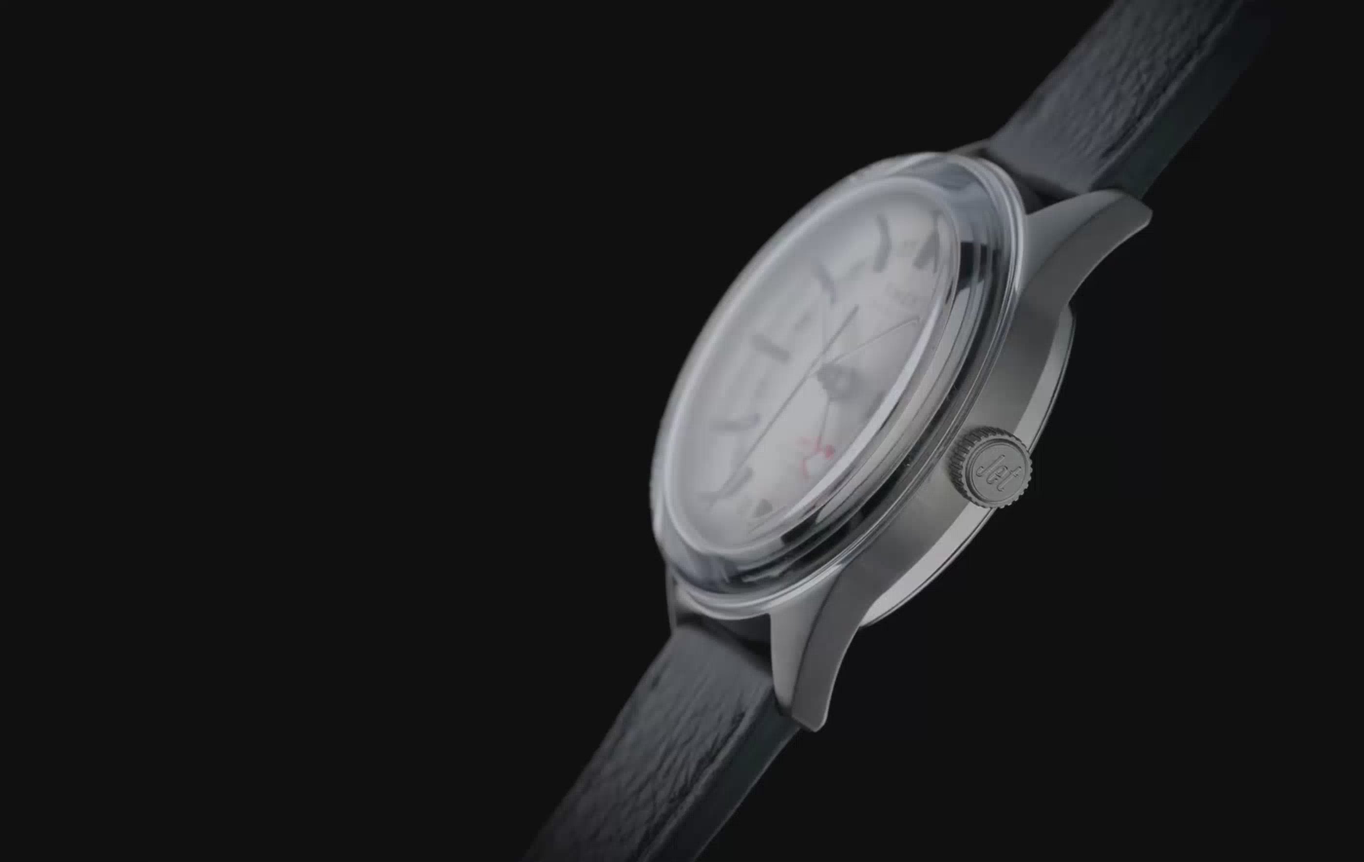 Marlin® Jet Titanium Automatic GMT watch rotating against a black background, highlighting its lightweight titanium case, silver-tone dial with 24-hour GMT scale, red GMT hand, black textured leather strap, side profile, and polished finishing from multiple angles before ending with a full front view.