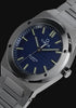Timex Q Marbella stainless steel watch with a blue textured dial, featuring rotating product views, close-up details of the brushed bezel and dial, and a full front view highlighting its integrated bracelet and modern design.