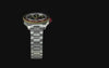 TW2Y93500 Waterbury Heritage Automatic GMT with a black dial, two-tone 24-hour bezel and stainless-steel bracelet, highlighting its glow-in-the-dark details.