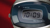 A rotating product video of the Q Timex® 1975 SSQ Digital Reissue watch showcasing its retro-inspired stainless-steel design. The video highlights the brushed metal case, integrated bracelet, and deep blue oval bezel framing the digital display that reads “10:09.”