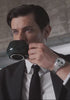 Video showcasing the Timex Marlin® Jet Quartz watch with a polished stainless-steel case, white dial, red seconds hand, and black, white, and red striped fabric strap. The video highlights the watch’s domed crystal, day-date window at 3 o’clock, and its vintage-inspired design, both in close-up detail and worn on the wrist.