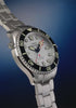 Rotating views of the Deepwater Meridian 200 HEV Automatic and its stainless-steel bracelet against a deep blue background.