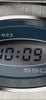 A rotating product video of the Q Timex® 1975 SSQ Digital Reissue watch showcasing its retro-inspired stainless-steel design. The video highlights the brushed metal case, integrated bracelet, and deep blue oval bezel framing the digital display that reads “10:09.”