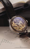 Harry Potter x Timex Waterbury Skeleton Automatic watch with black leather strap displayed on Hogwarts acceptance letters beside a red wax seal and open book, showcasing the intricate gold-tone skeleton dial.