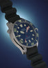Rotating views of the blue Deepwater Meridian 200 HEV Automatic with a black rubber strap against a dark blue background.