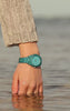 It is a video which shows a woman wearing Timex Legacy Ocean Watch while playing the surface water in sea.