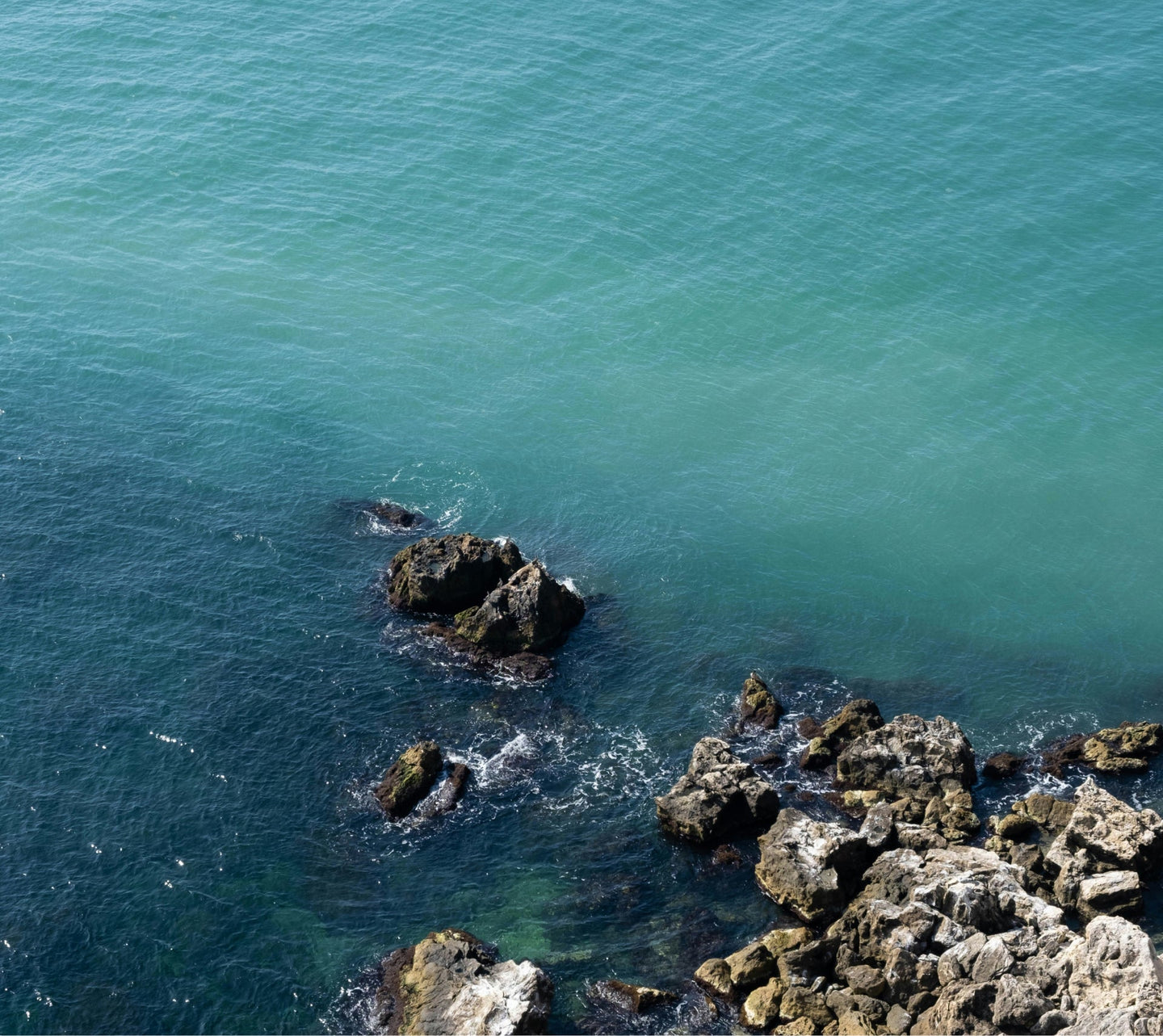 An Image of an ocean with rocky shore